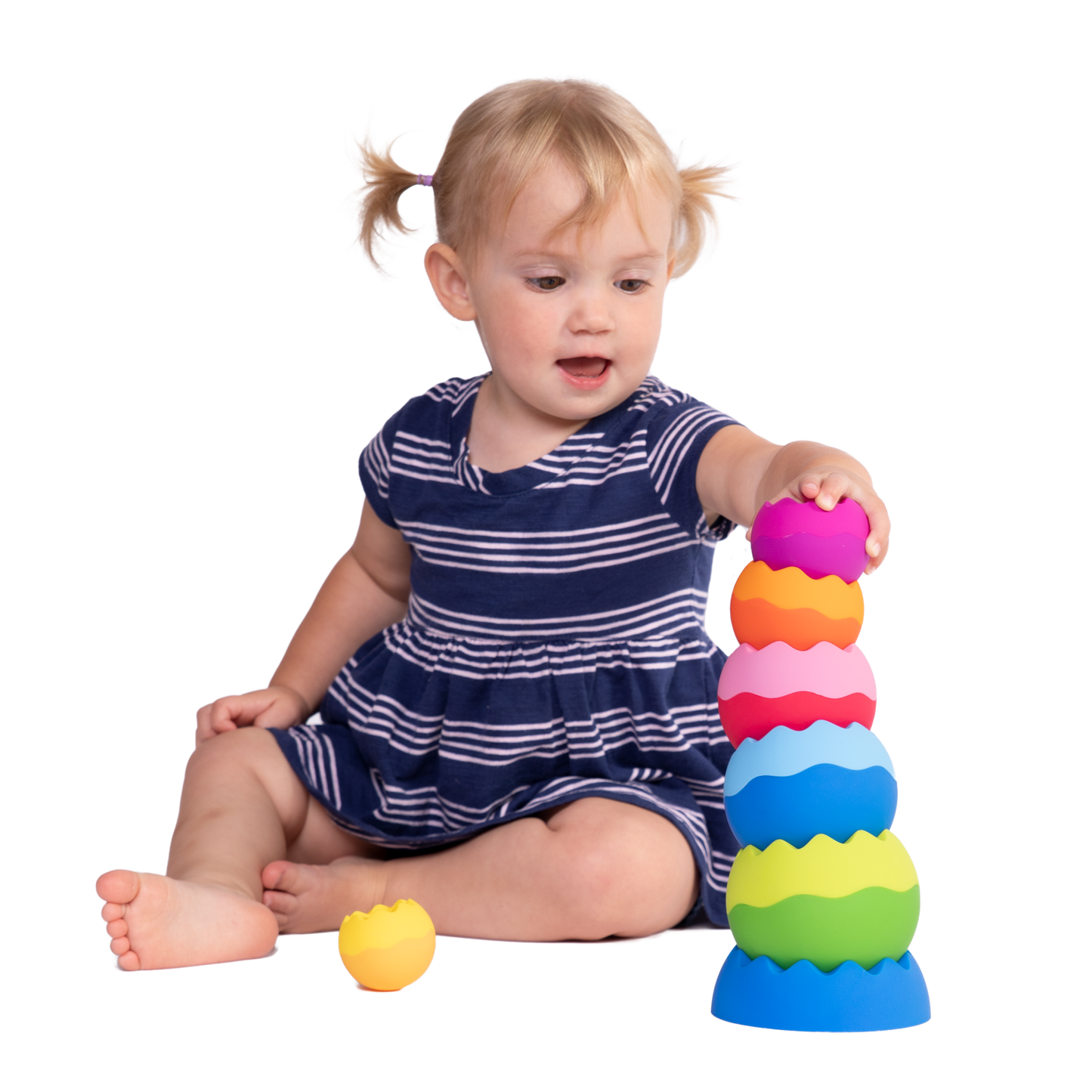 Colorful stacking toy with tactile texture, featuring interlocking rings in vibrant rainbow hues.