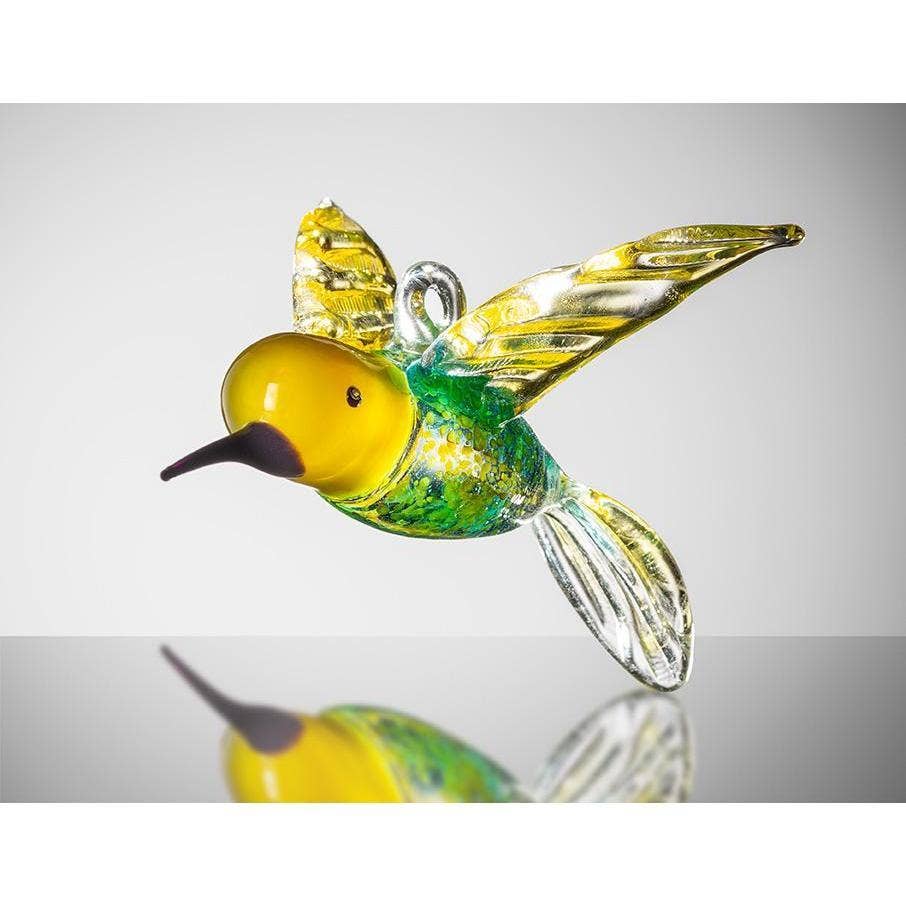 A vibrant yellow and blue glass hummingbird ornament with intricate details and a shiny finish.