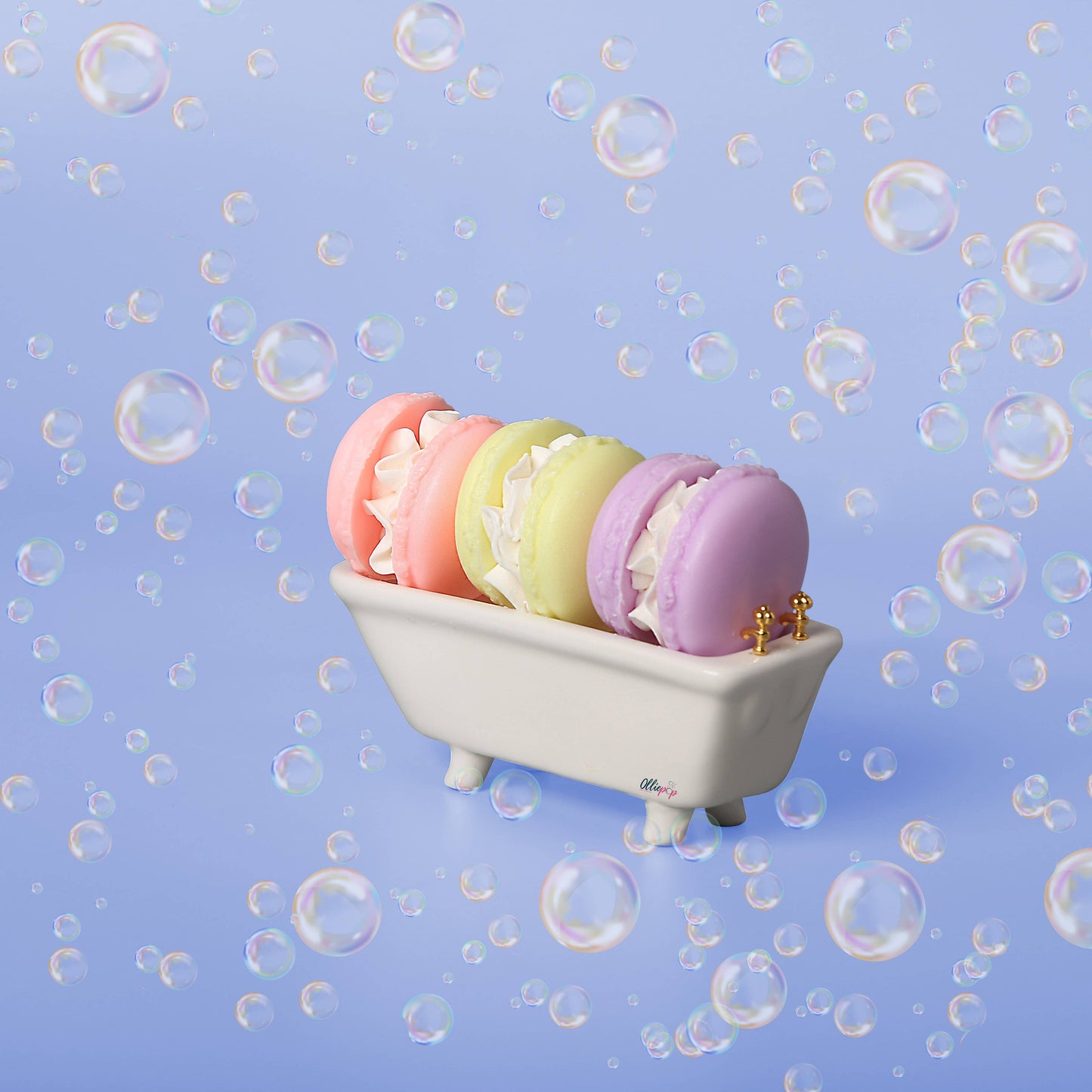 Pastel-colored macaron-shaped soaps in lavender, citrus, and floral scents, nestled in a mini bathtub.