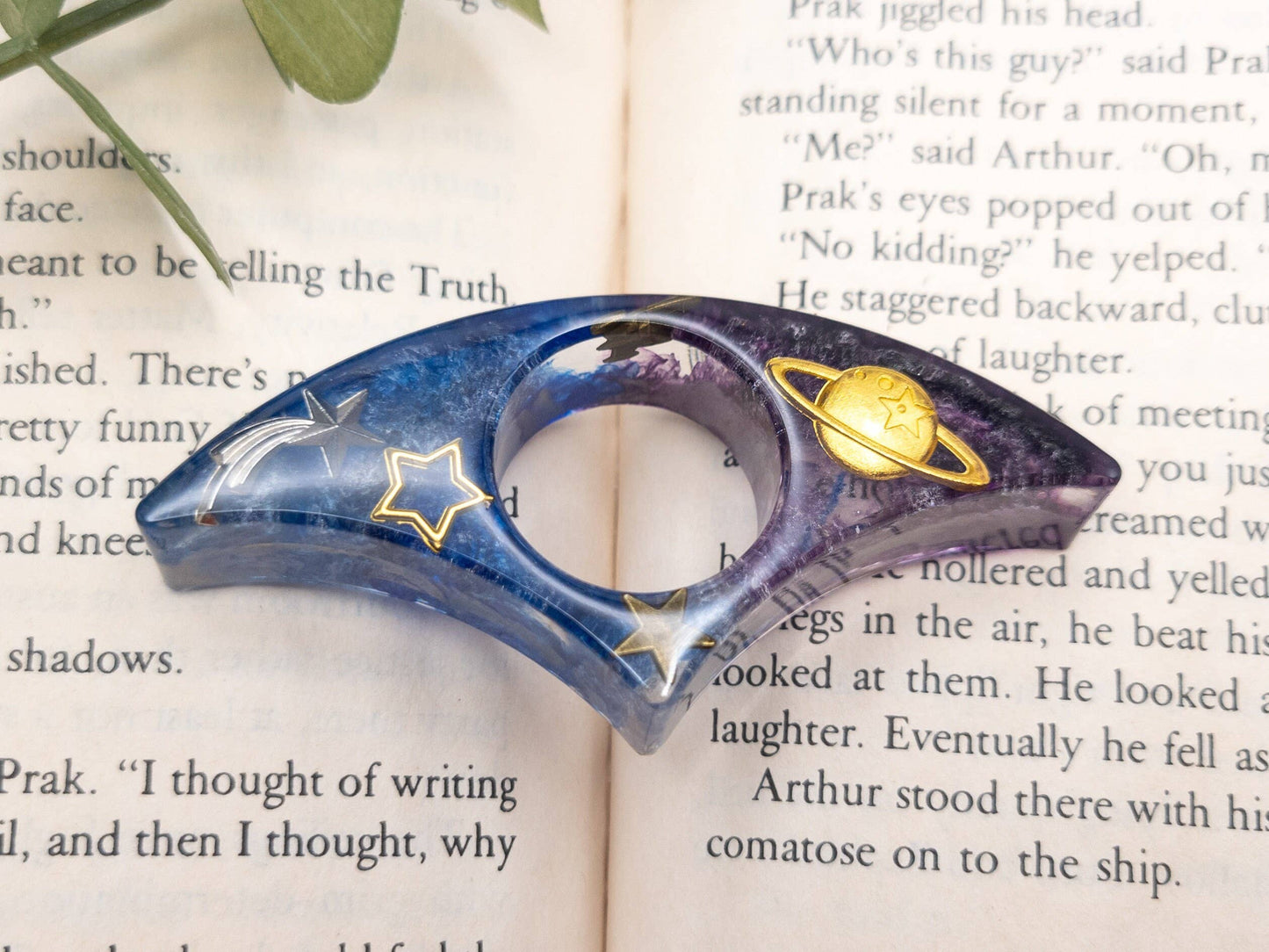 Purple and blue resin book page holder with gold stars and a planet, perfect for galaxy-themed decor.