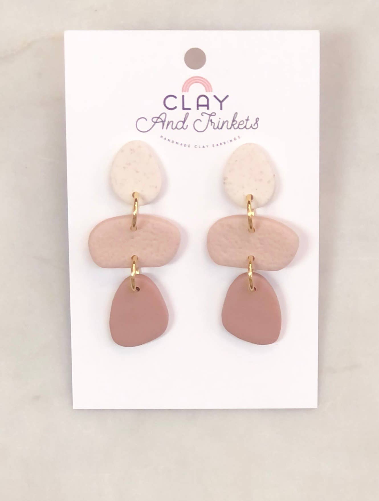 Trio of blush-toned clay dangle earrings with gold attachments