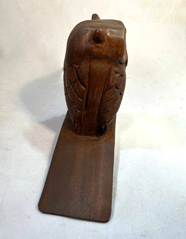 Hand-carved wooden owl doorstop with detailed feather patterns and a sturdy base.