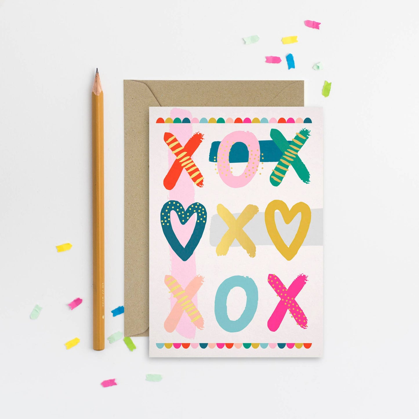 Colorful XOXO card with bold heart and cross designs and kraft envelope