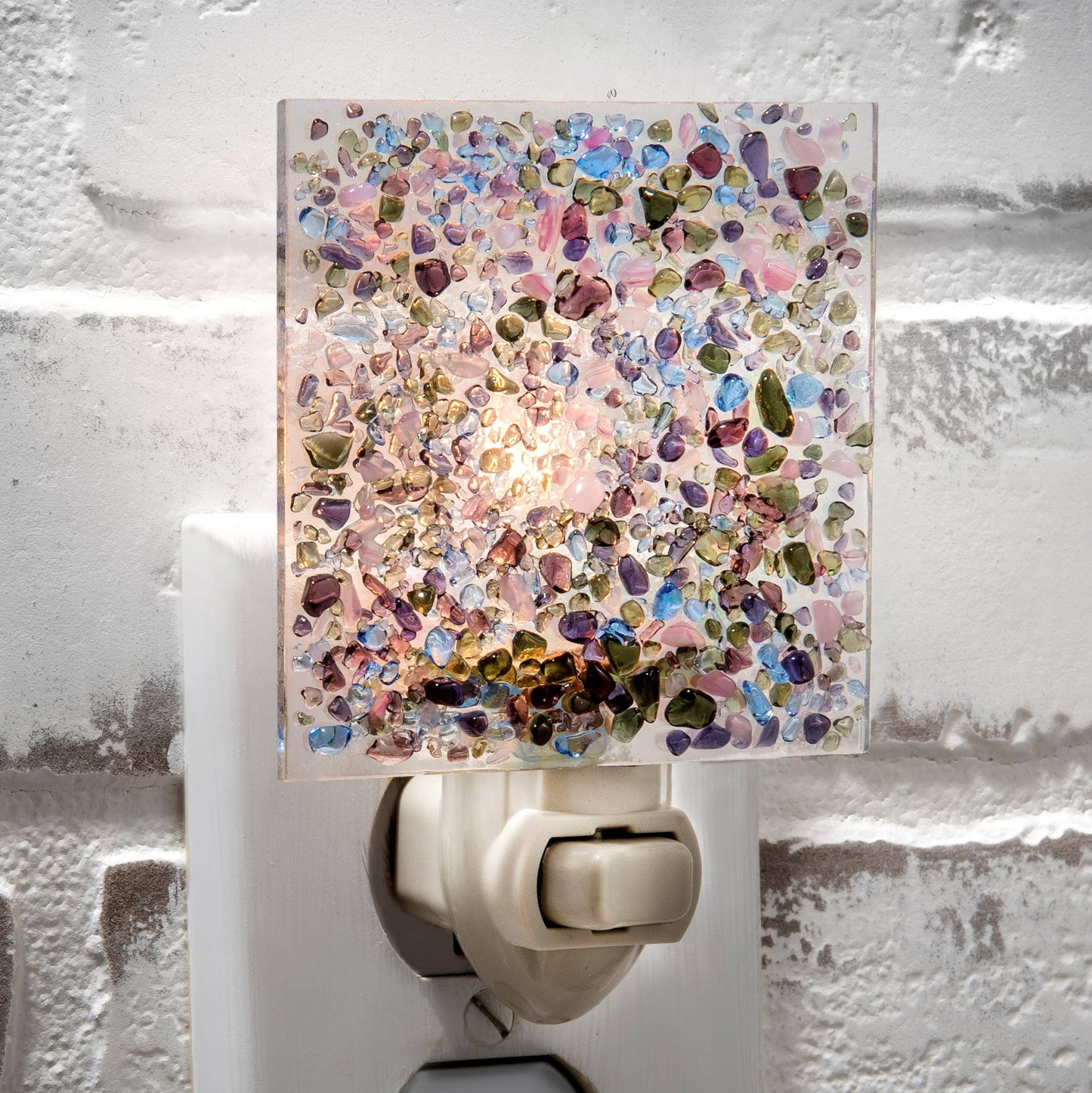 Colorful fused glass night light with purple, blue, green, and pink chips on iridescent background