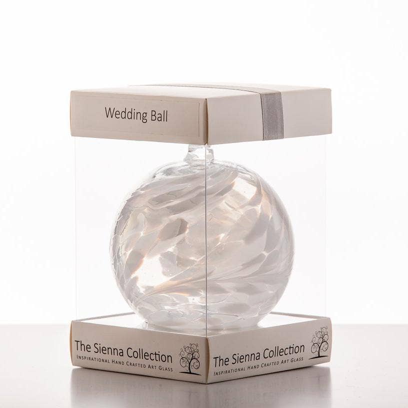 A 10cm white glass friendship ball with intricate swirls, perfect as a wedding ornament.