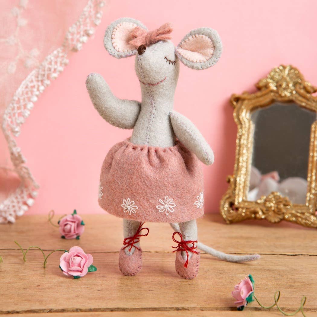 Felt mouse ballerina craft doll with pink skirt and bow, standing on wooden table