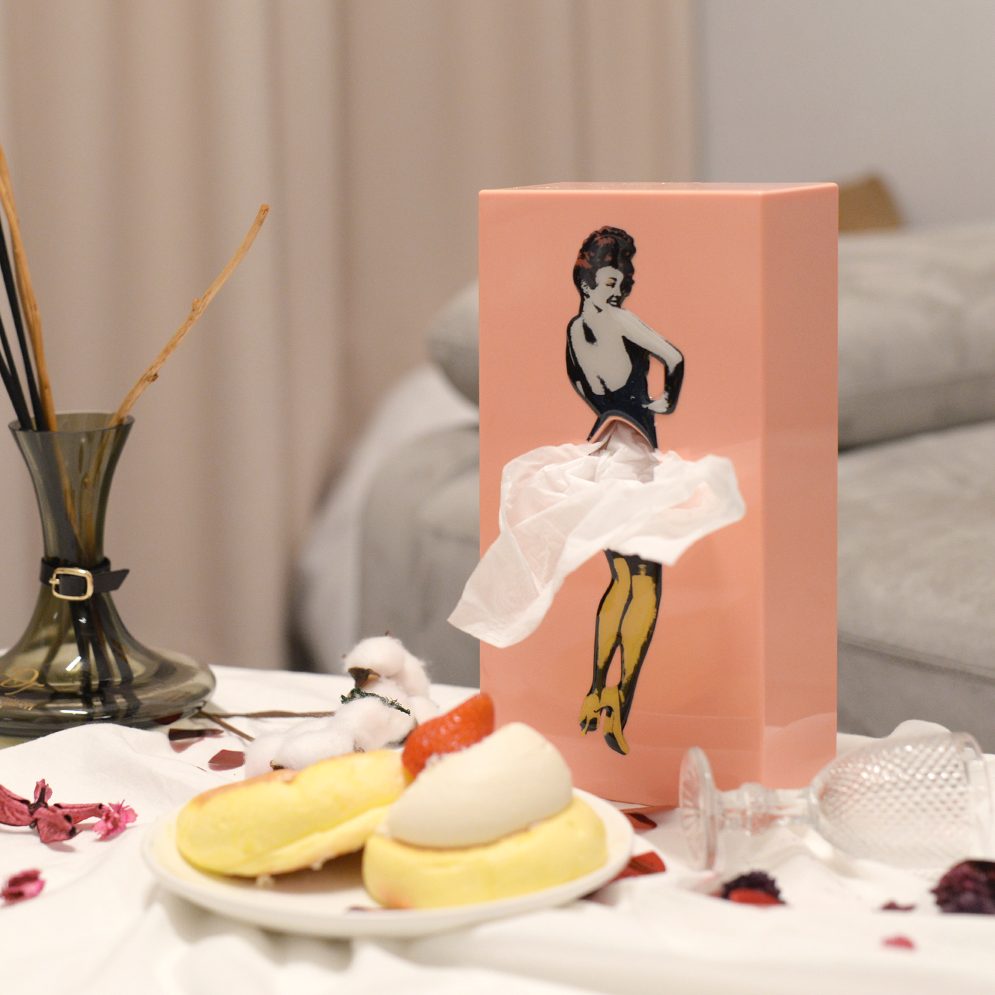 Pink tissue box with a pop art design of a woman in a flying skirt, perfect for quirky decor.