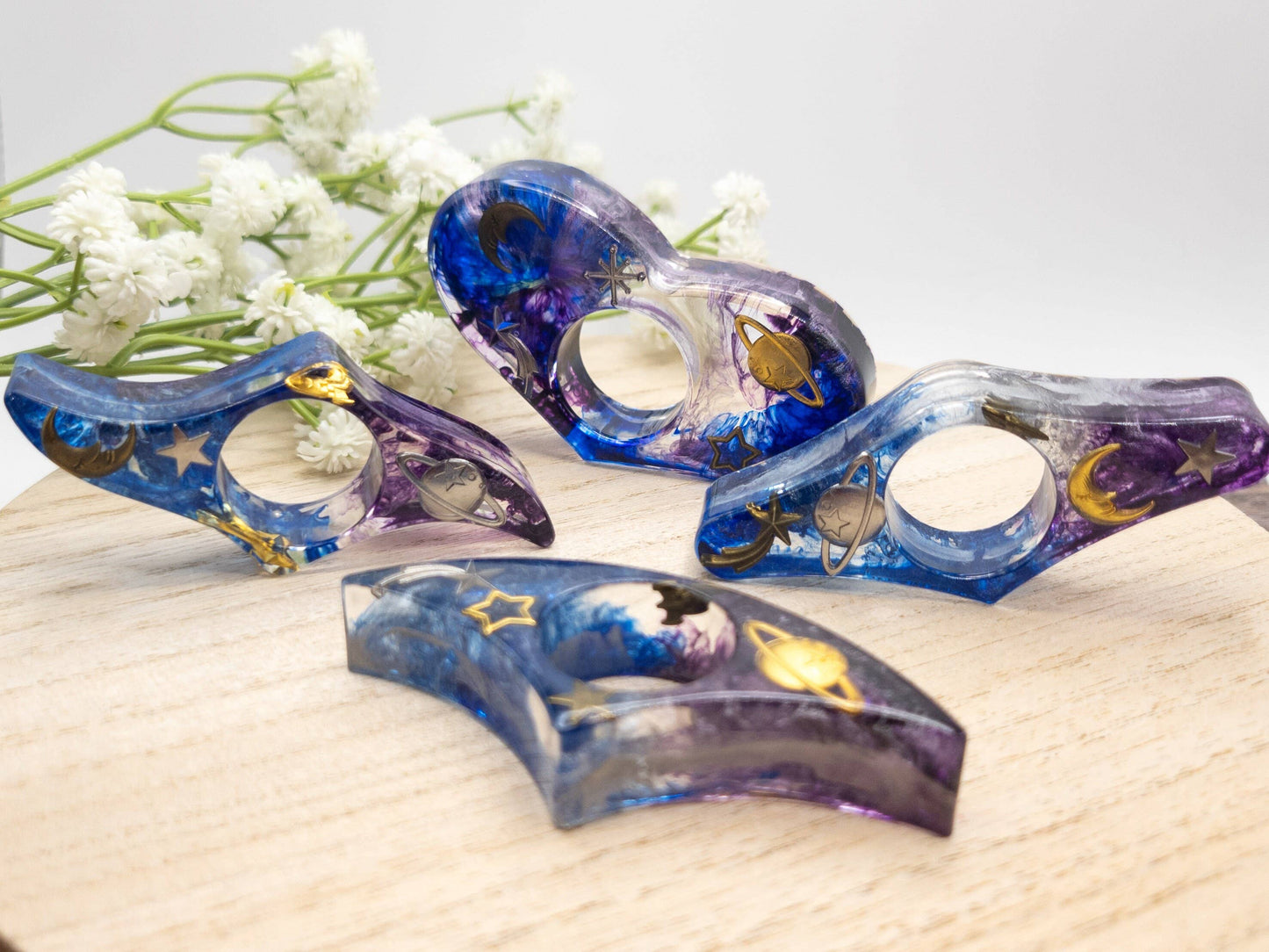 Purple and blue resin book page holder with galaxy design and celestial details.