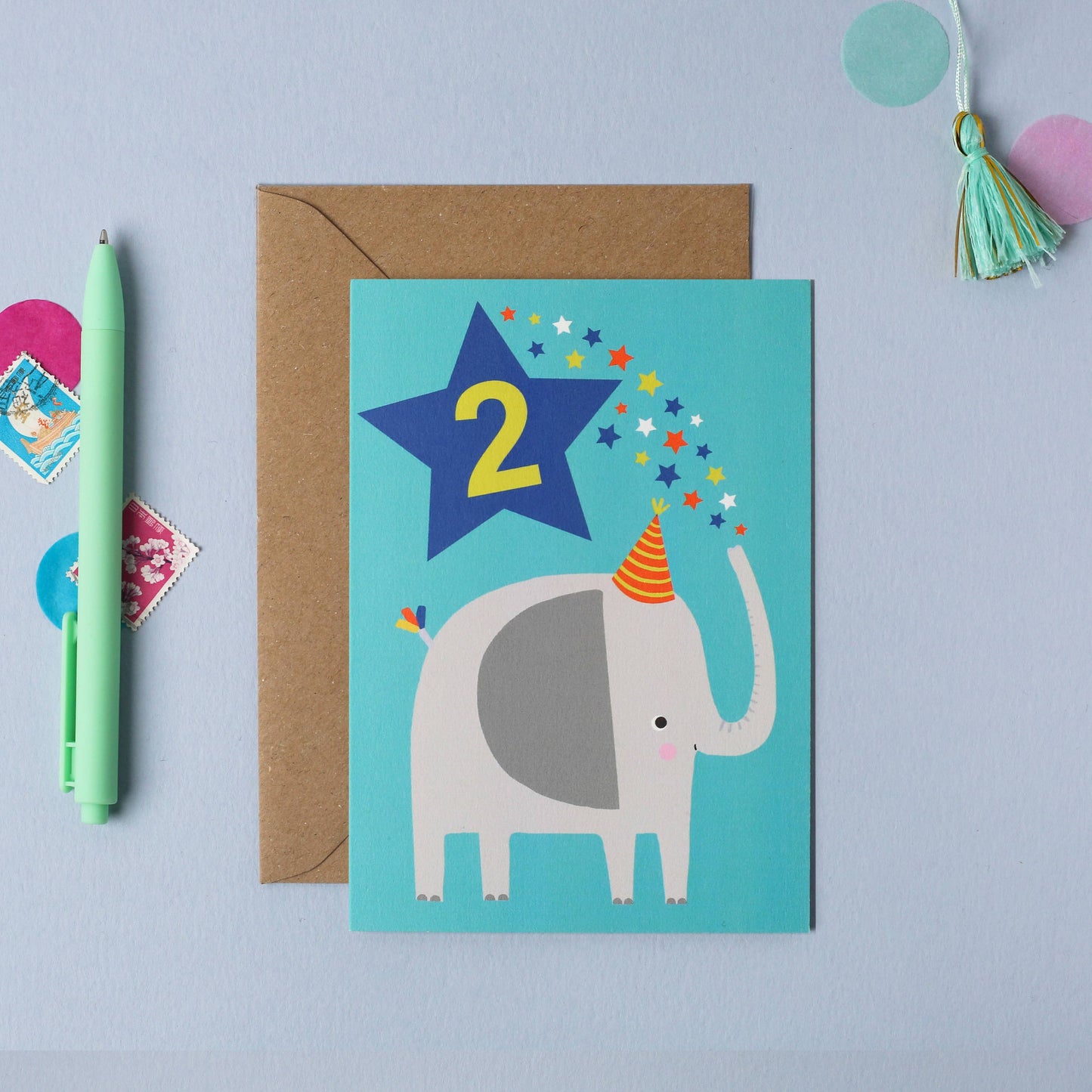 Elephant-themed 2nd birthday card with star and party hat on blue background