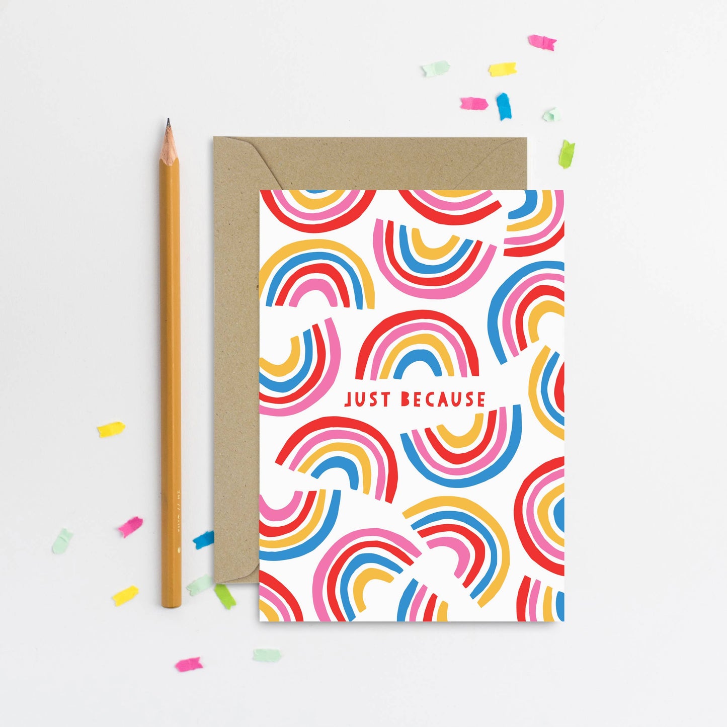 Colorful rainbow greeting card with 'Just Because' text and kraft envelope.