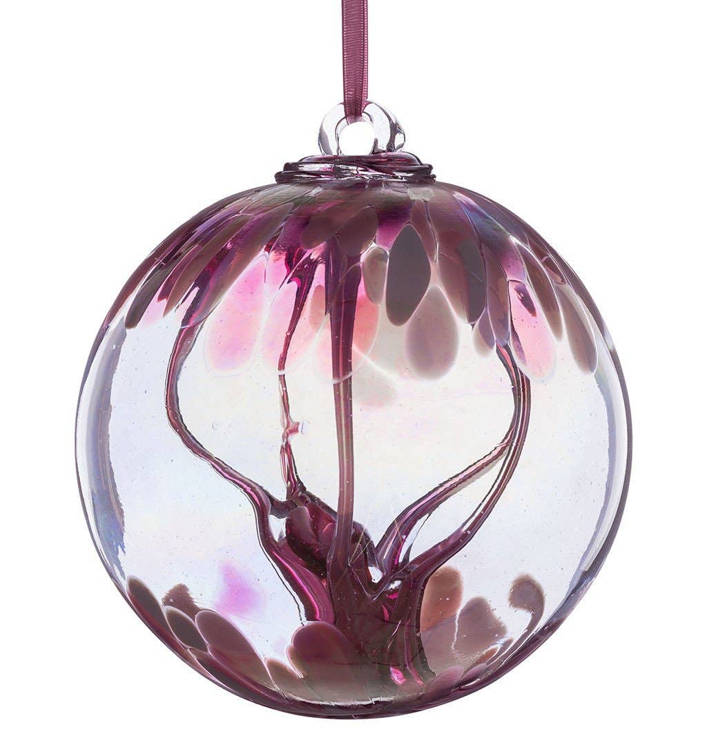Pastel pink glass spirit ball with swirling patterns and ribbon loop