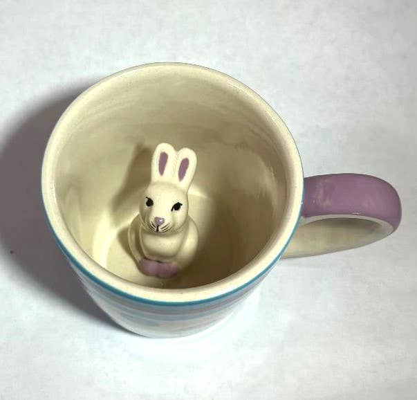 Ceramic toddler cup with a lavender handle and a white bunny figurine at the bottom, accented with pink paws and ears.