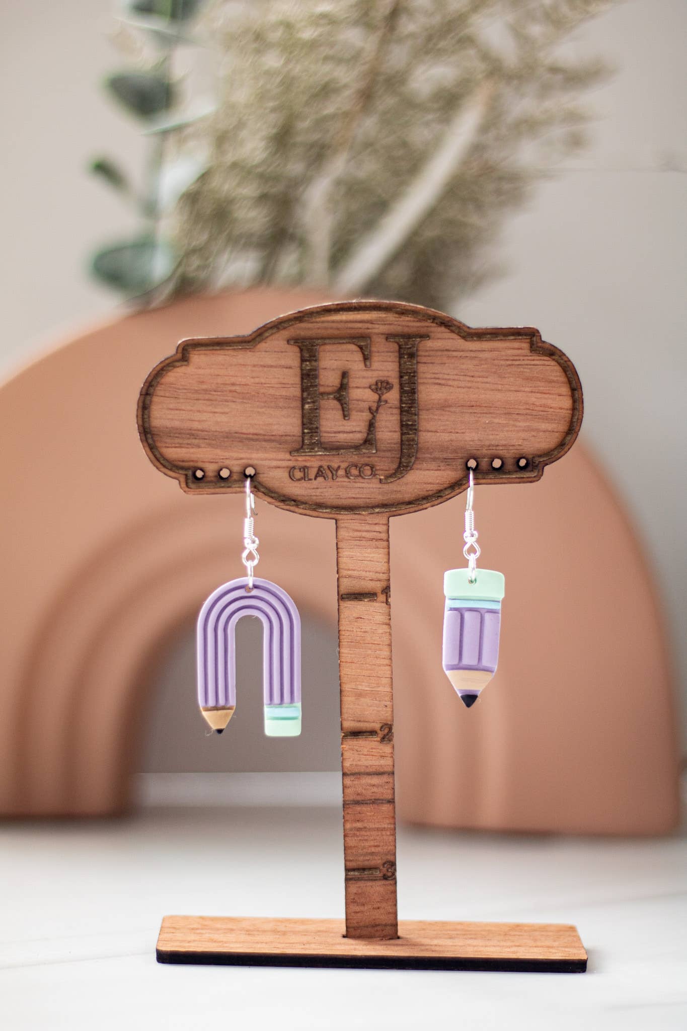 Blue pastel pencil-shaped dangle earrings with a playful, colorful design.