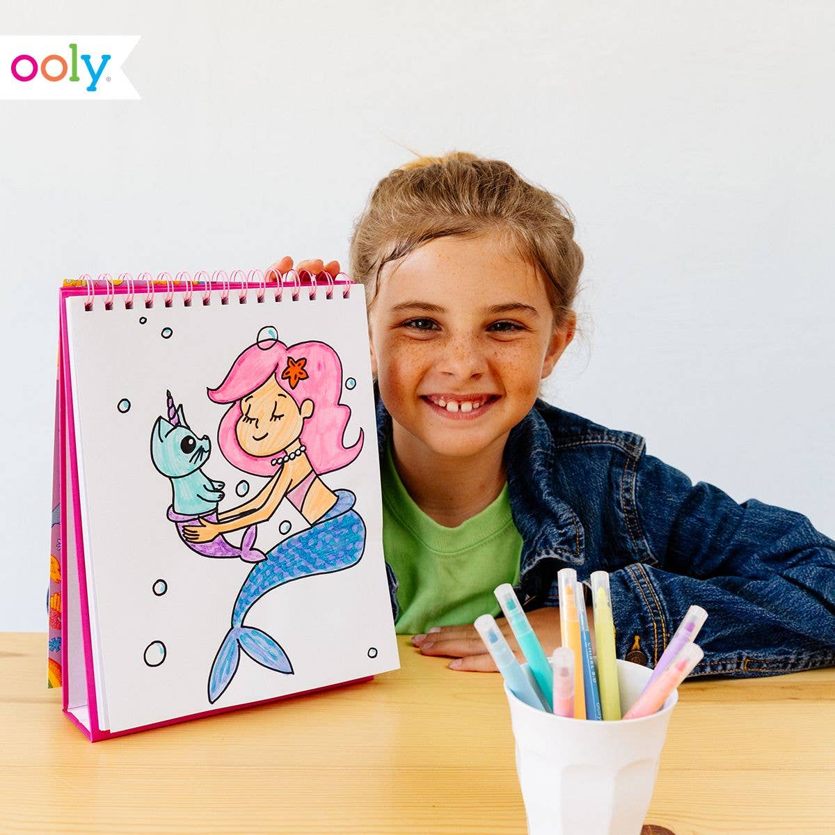 Standing sketchbook with perforated pages, featuring a colorful mermaid doodle on the cover.