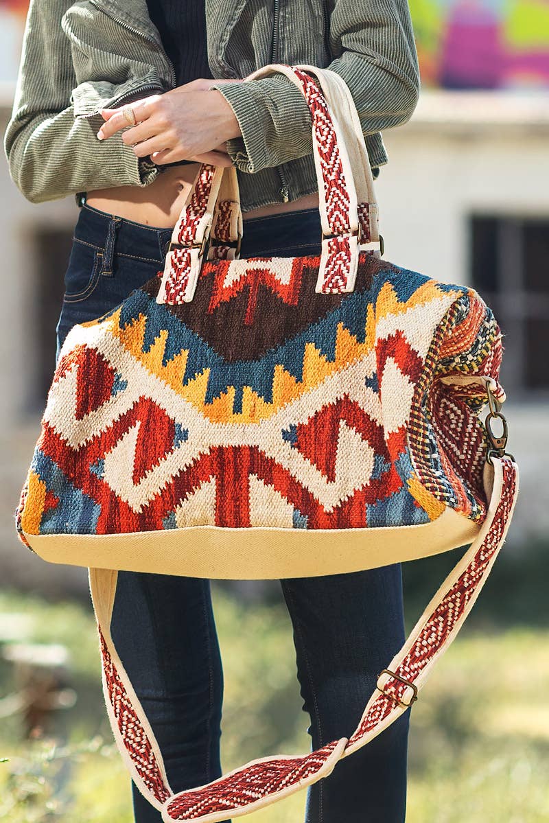 Handmade weekender bag with vibrant boho Navajo pattern, featuring colorful geometric designs and woven straps.