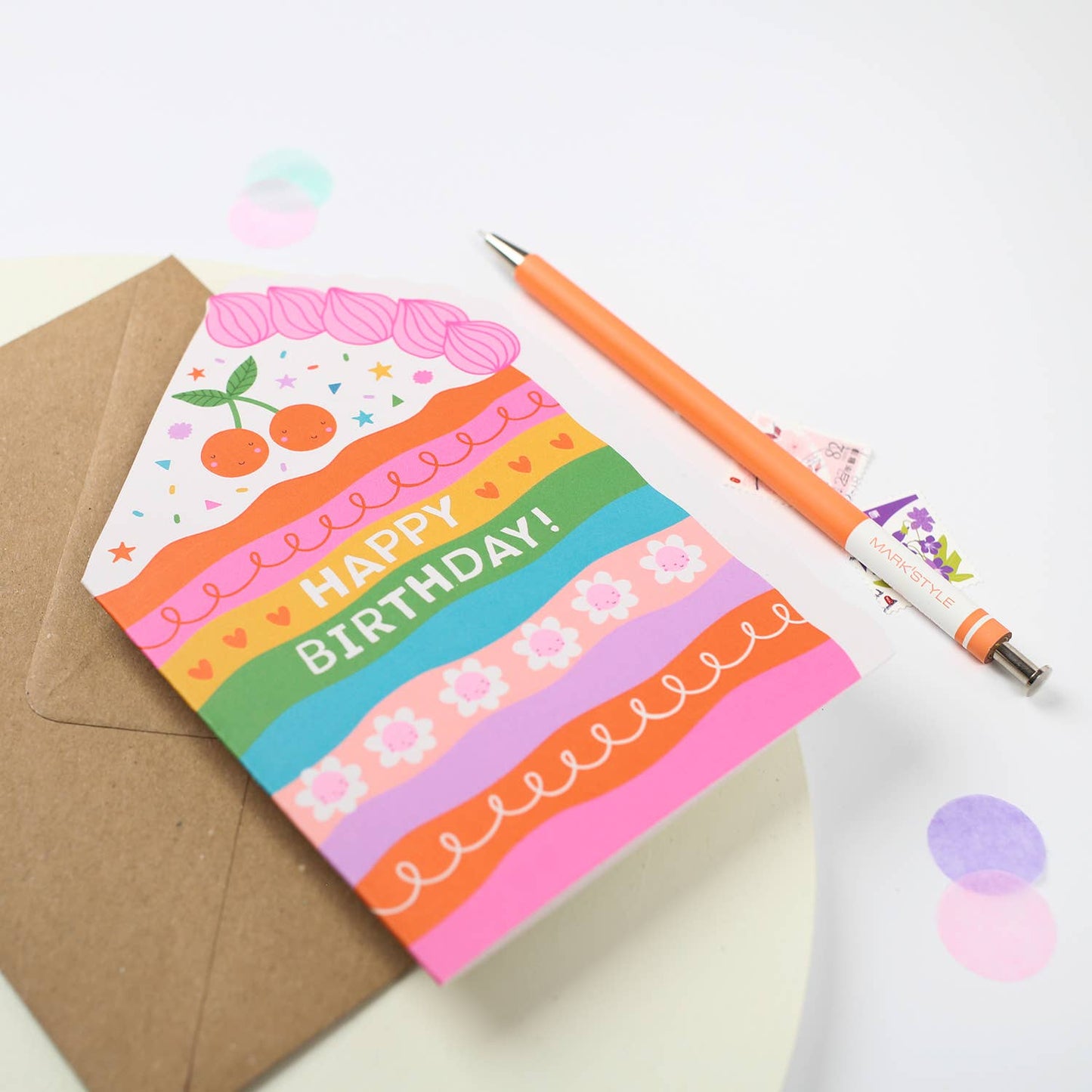 A colorful rainbow cake die-cut birthday card with playful designs and a "Happy Birthday!" message.