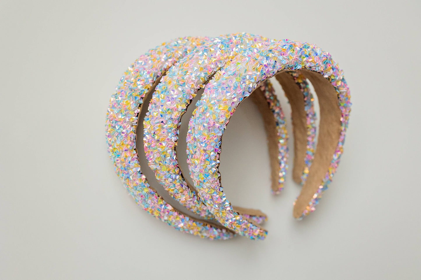Pastel headband adorned with iridescent crystals, perfect for a festive party look.