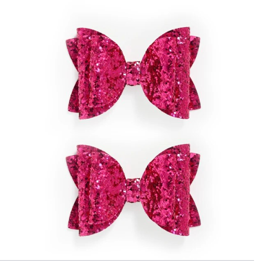 Two glittery magenta pink hair clips designed to sparkle in the light.