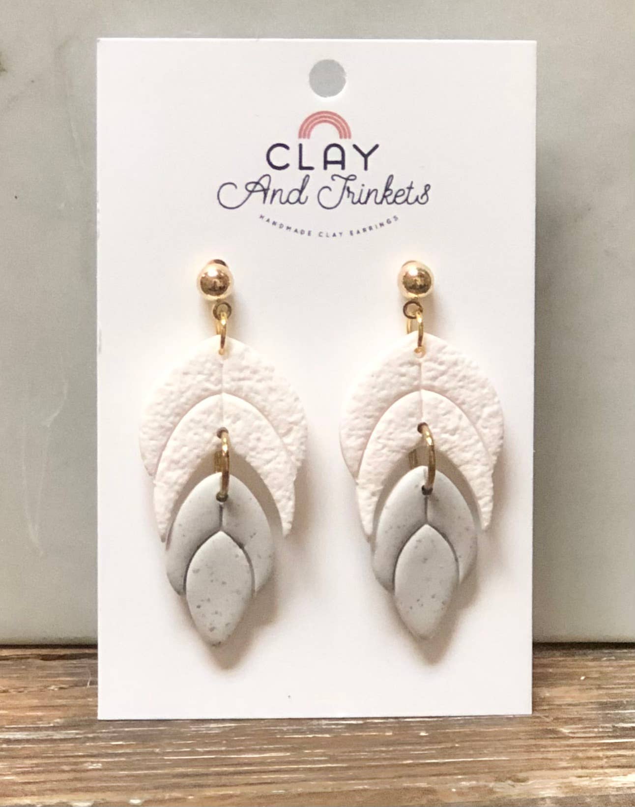 Layered clay leaf dangle earrings in white and grey tones with gold posts