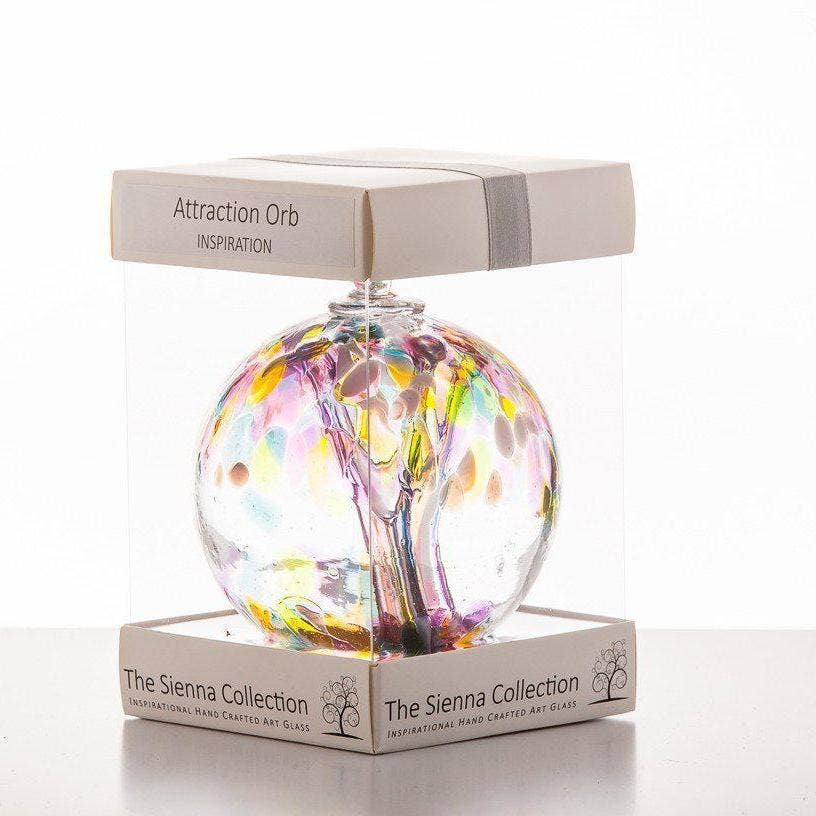 A handcrafted glass orb with a colorful tree design, perfect for inspiration and unique gifting.