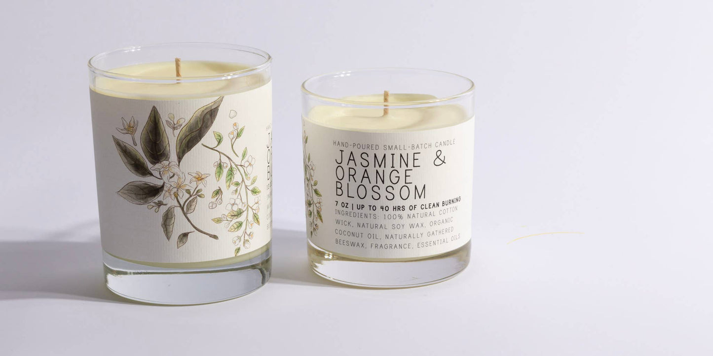 Large glass candle with jasmine and orange blossom botanical label, made with natural ingredients and a cotton wick.