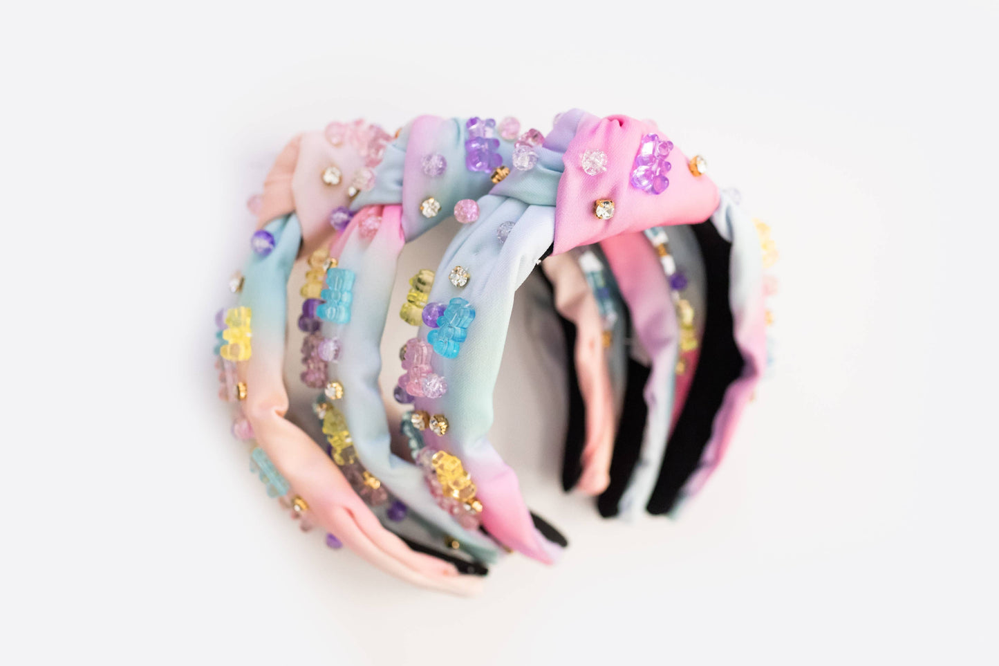 Pastel beaded headband adorned with colorful jewel gummy bear accents for a playful and sparkly look.