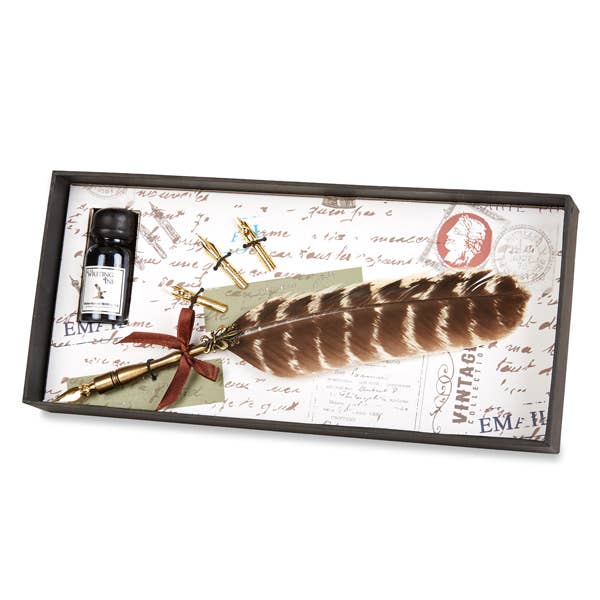 A brass feather nib pen set with a burgundy feather, presented in a stylish gift box.