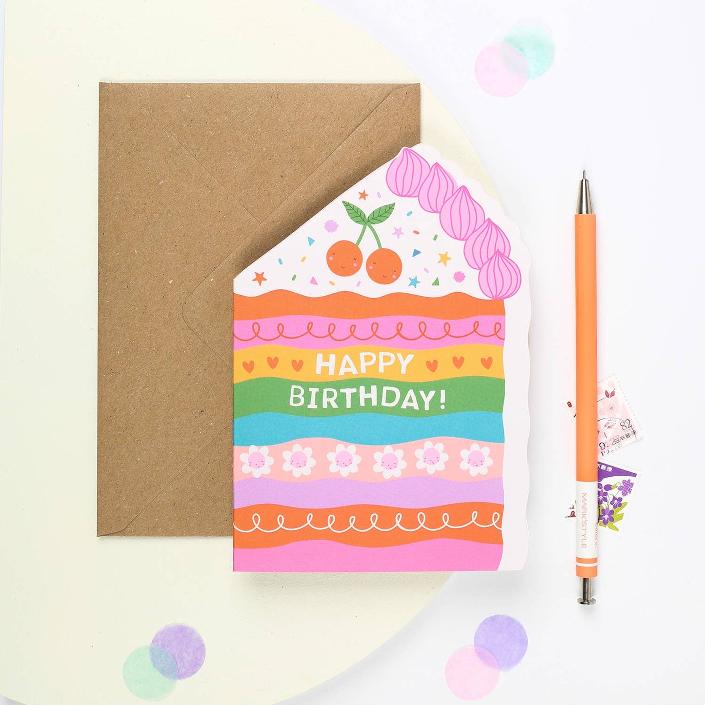 A colorful, handmade birthday card featuring a rainbow cake design with "Happy Birthday!" text.