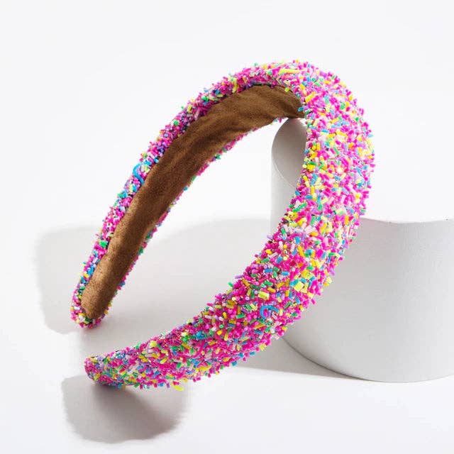 Colorful beaded headband with pink, yellow, and blue sprinkle-like beading on a soft band