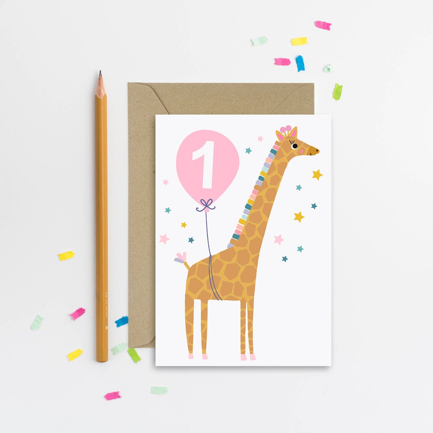 A cheerful 1st birthday card featuring a giraffe holding a pink balloon with the number 1, surrounded by colorful stars.