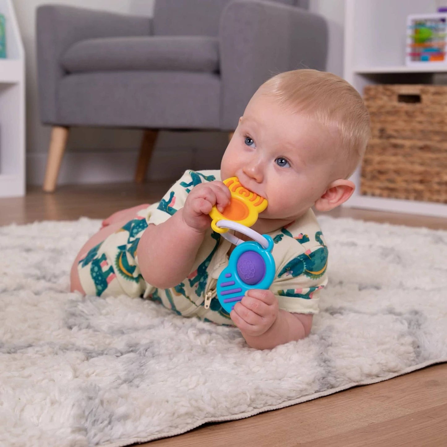 A baby holds a Sensory Ring Toy Set featuring two colorful rings with textured surfaces.