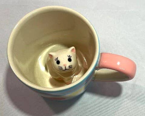 Ceramic baby cup with a hidden kitty cat figurine inside