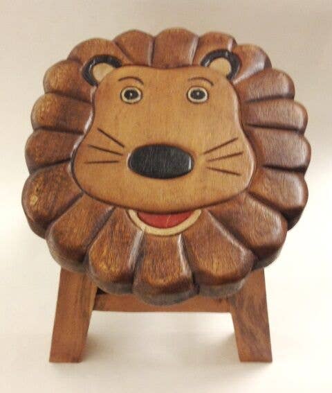 Wooden lion-shaped stool with carved face and happy expression