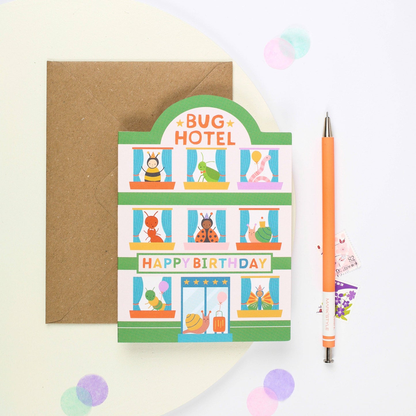 Colorful children's birthday card shaped like a hotel with cheerful cartoon bugs.