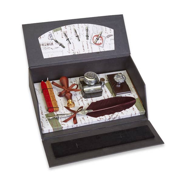 Vintage quill writing set with pewter accents, featuring a crimson feather and elegant calligraphy tools.