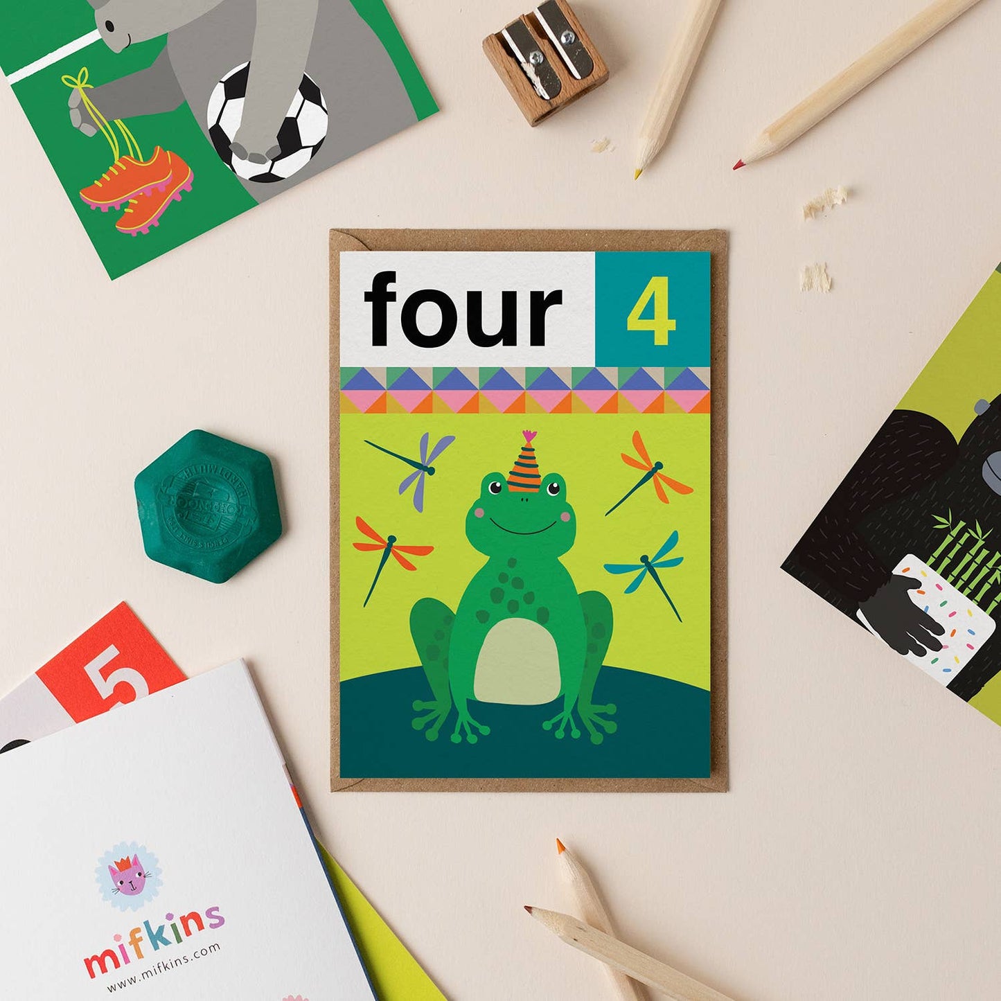 Gender-neutral 4th birthday card featuring a cheerful green frog with a party hat and colorful dragonflies.