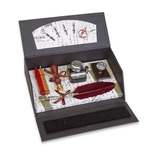 Vintage-style writing set with red quill, ink bottle, blotter, and accessories in a gift box
