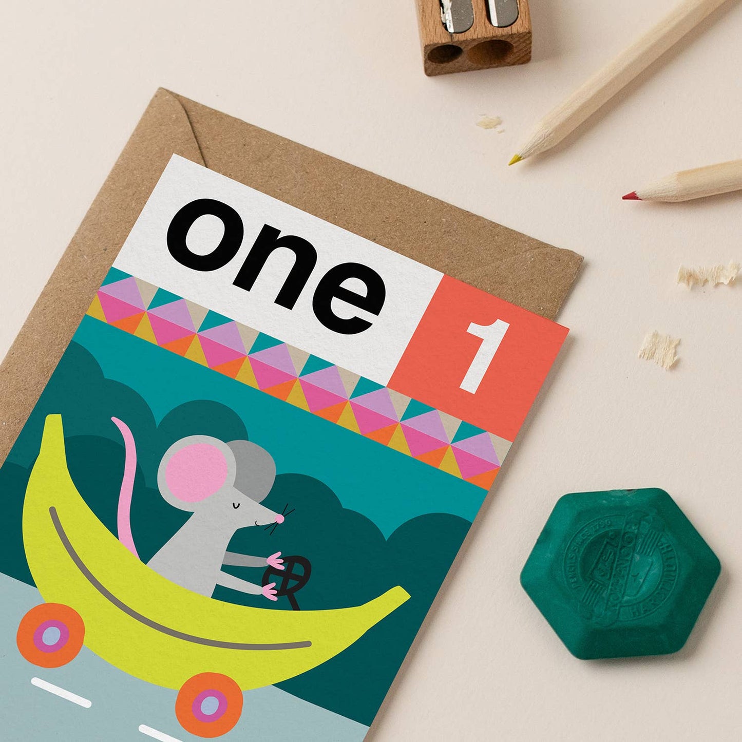 A colorful children's birthday card featuring a mouse in a banana car, perfect for a 1st birthday celebration.