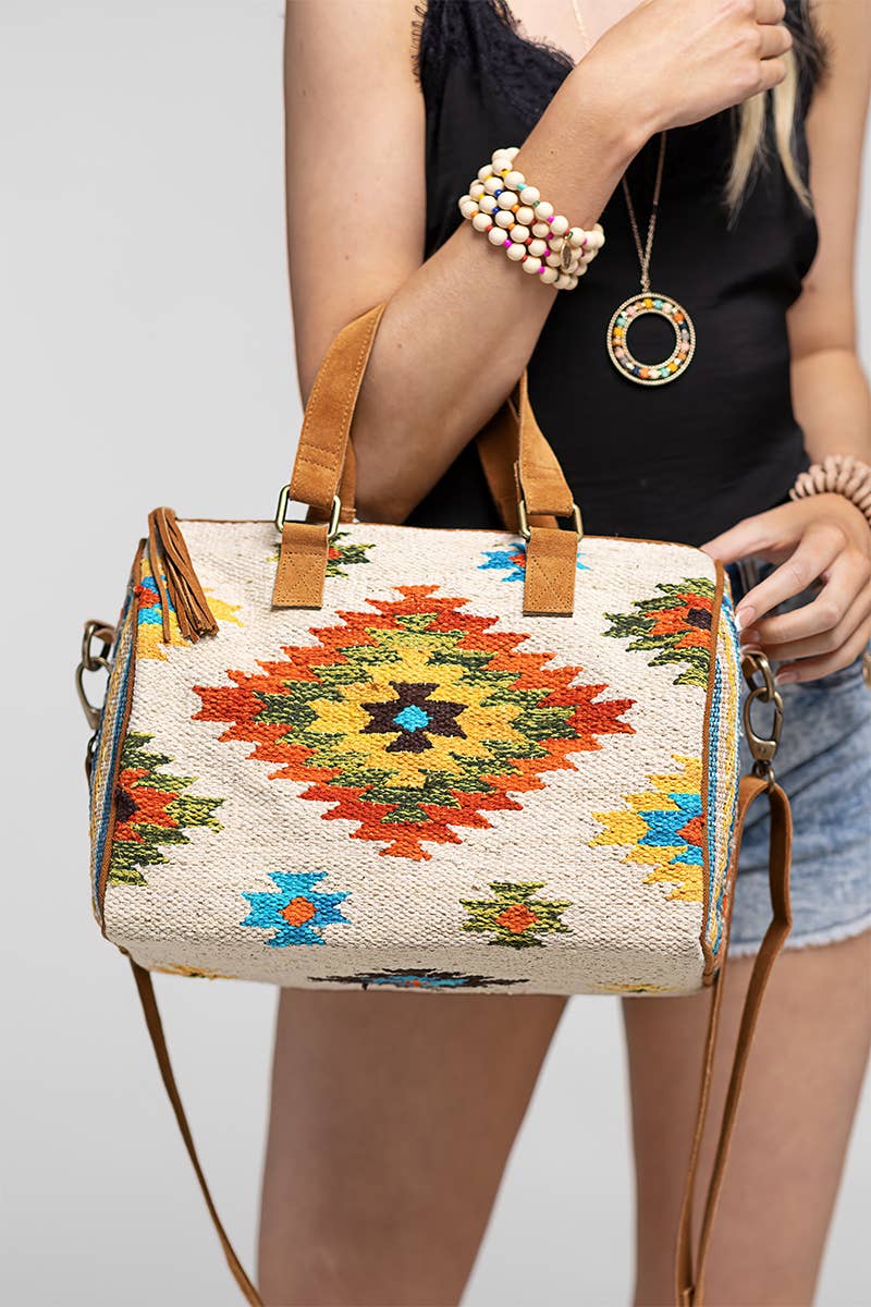 A colorful, handmade ethnic motif Boston bag with suede handles and tassels.
