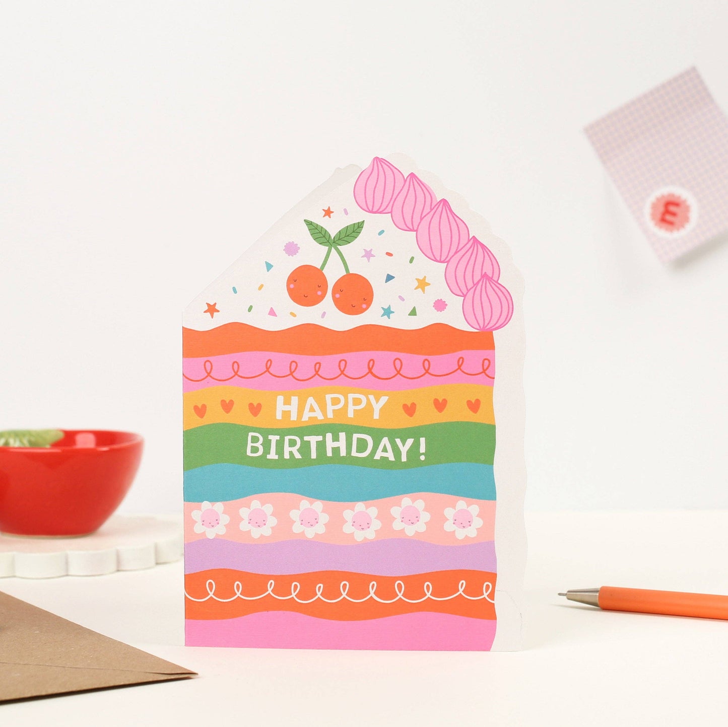 Rainbow cake-shaped birthday card with cherries and decorative layers