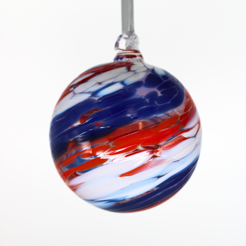 Hand-blown glass ball with red, white, and blue swirls