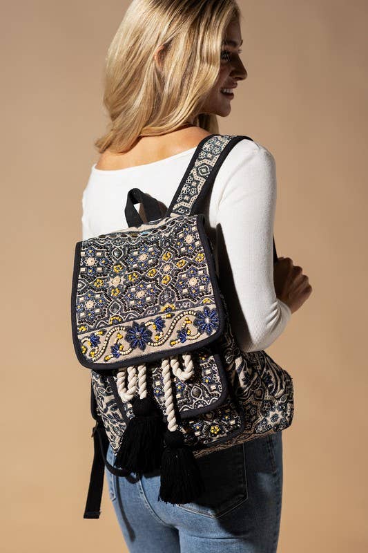 Hand-beaded bohemian backpack with tassels and intricate floral patterns