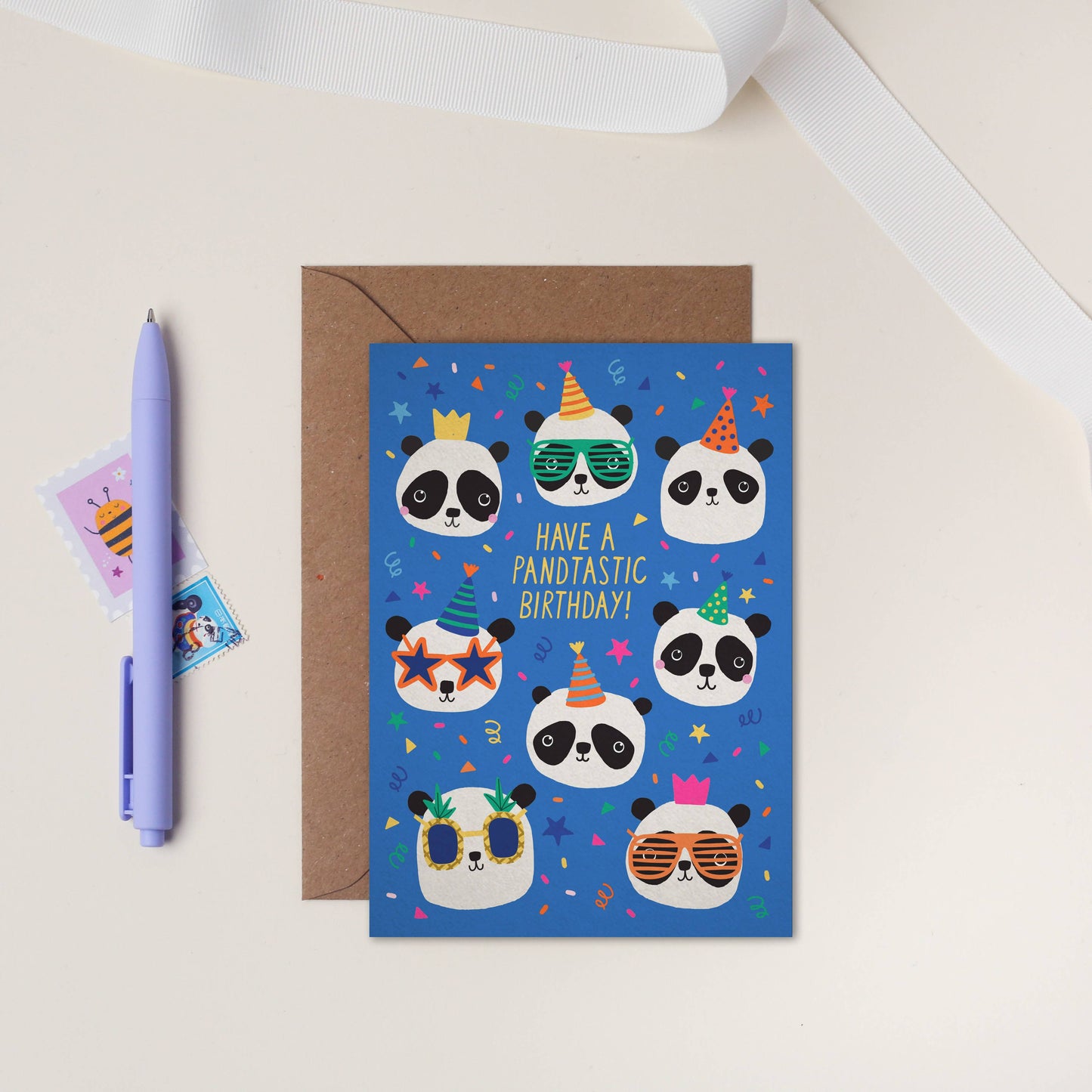Bright blue birthday card featuring party pandas with colorful hats and sunglasses, perfect for kids.