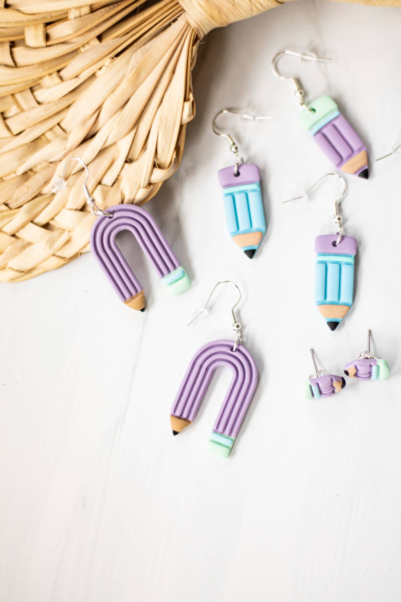 Blue pastel pencil-shaped dangle earrings with a charming, whimsical design.