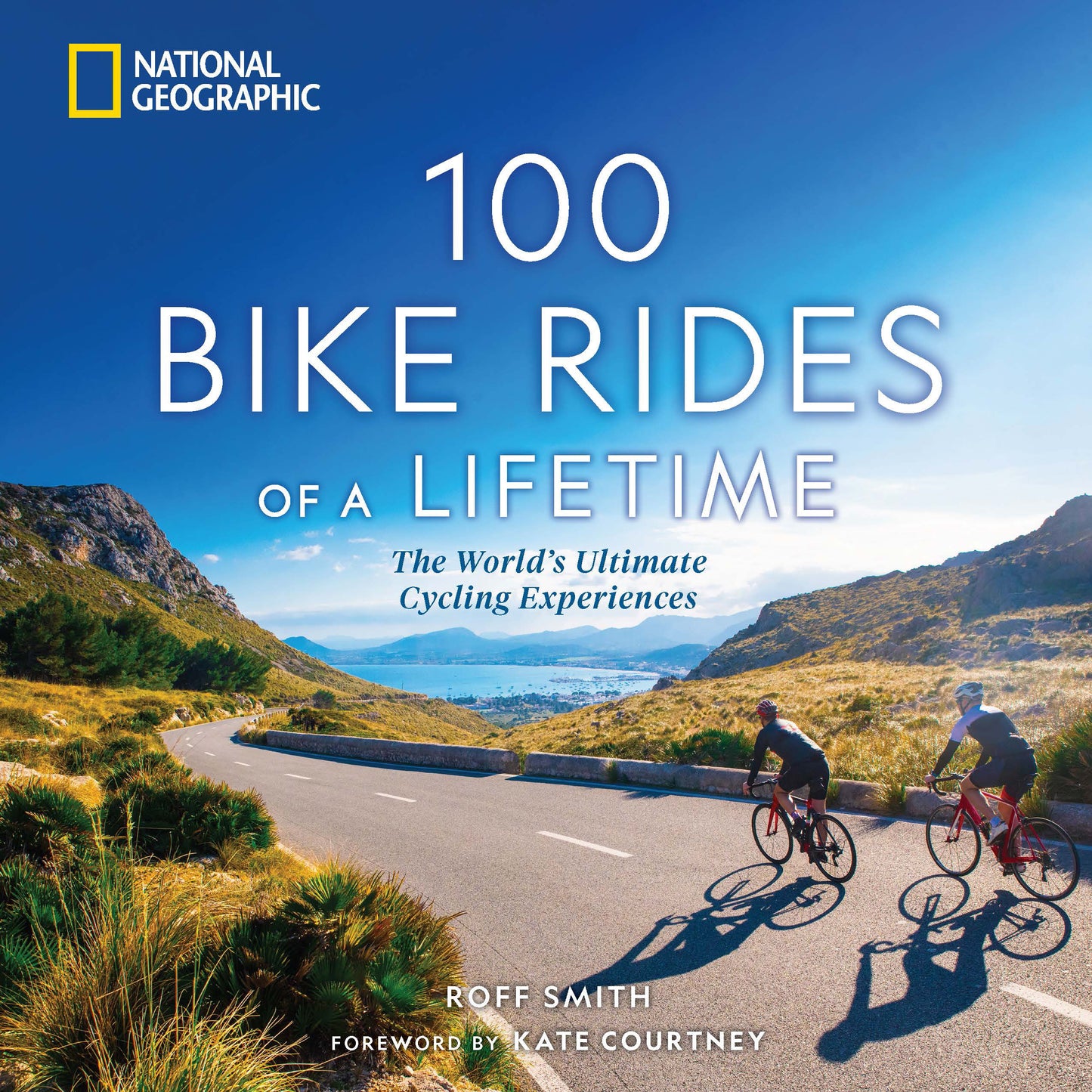 Cover of a cycling travel book with two cyclists riding on a scenic road near mountains