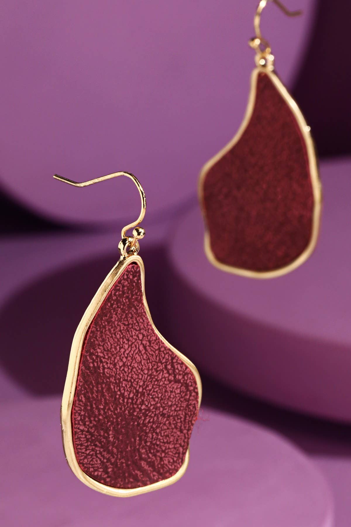 Red organic-shaped dangle earrings with gold trim