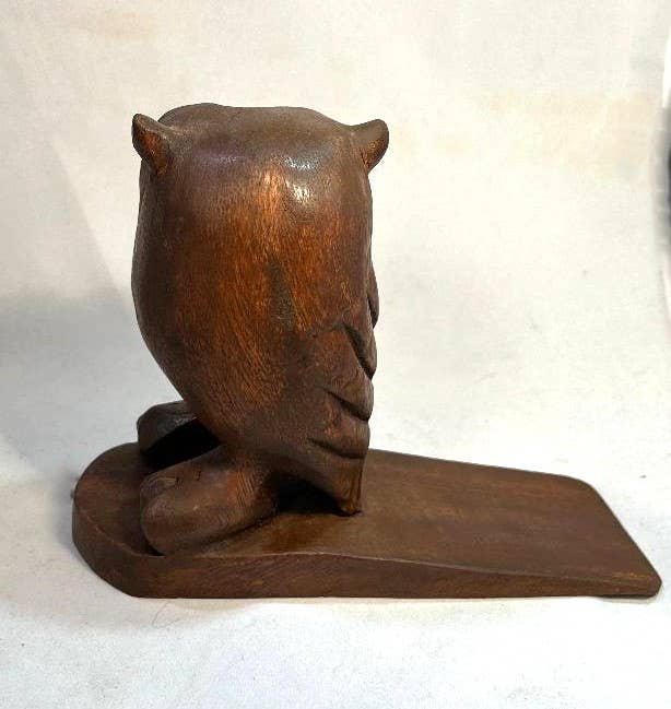 Hand-carved wooden owl doorstop with a smooth finish and charming details.