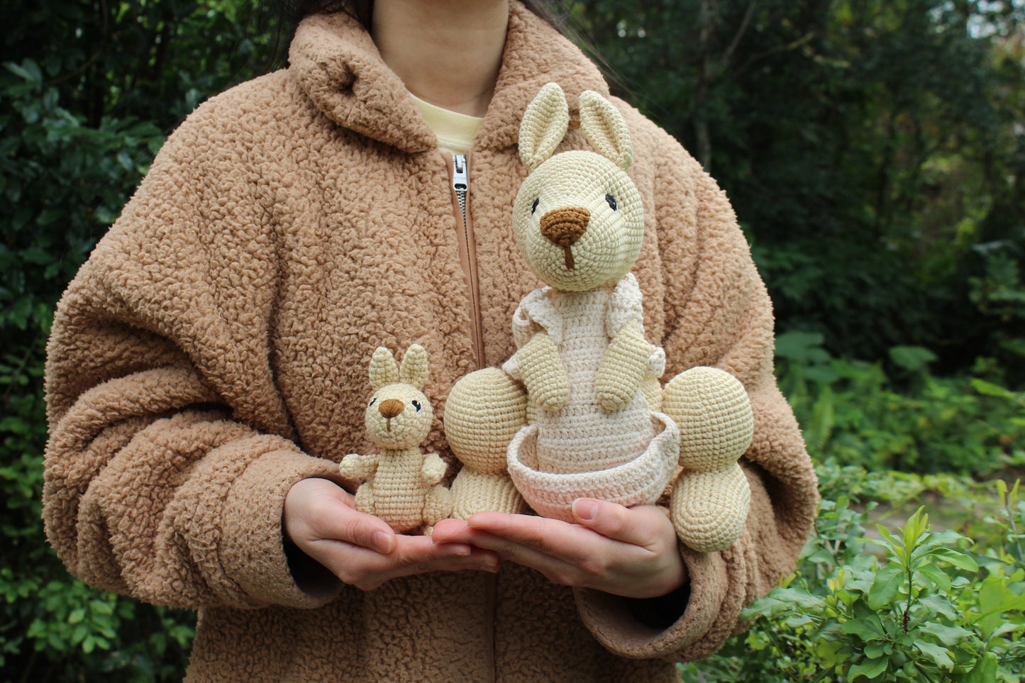 A handmade crochet kangaroo set with a larger parent and smaller baby, both in cream color.