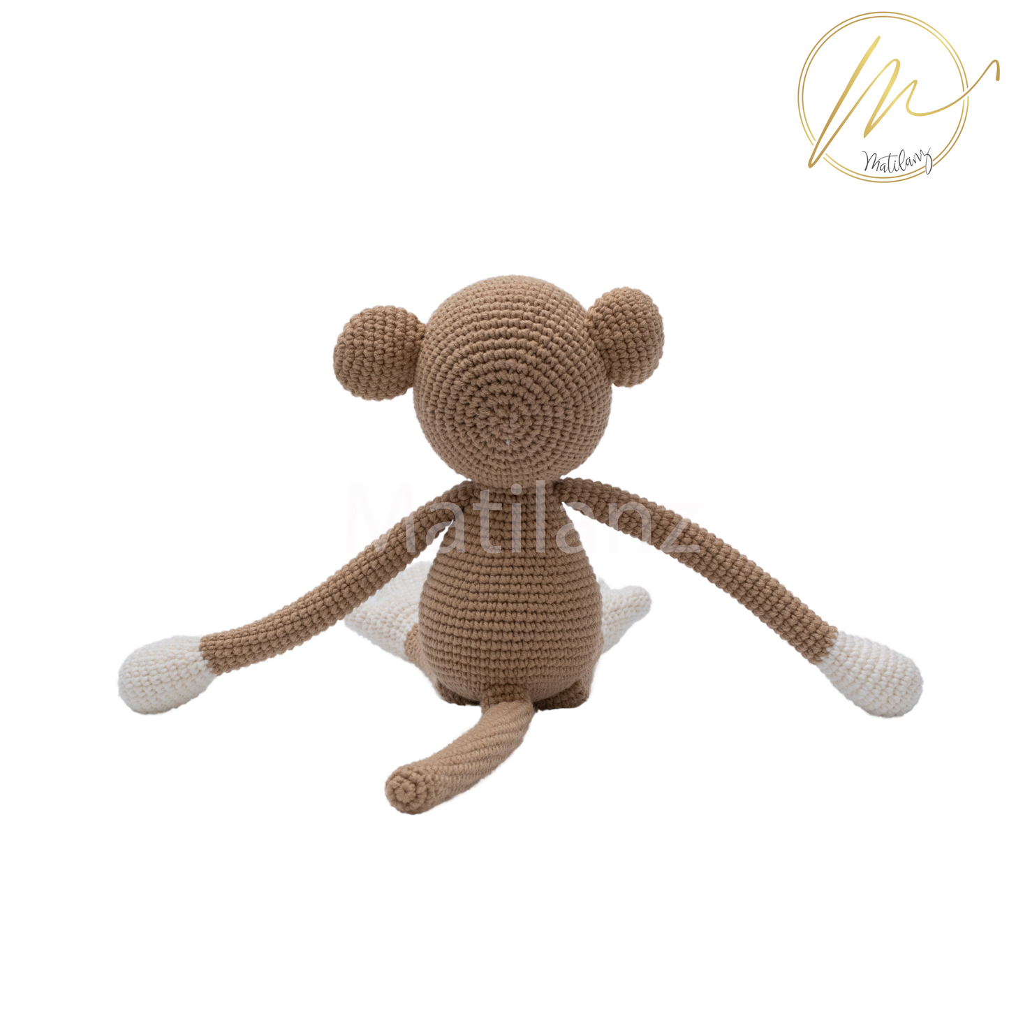 A handmade 13-inch crochet monkey made of soft beige and cream yarn, with long limbs and a cute expression.