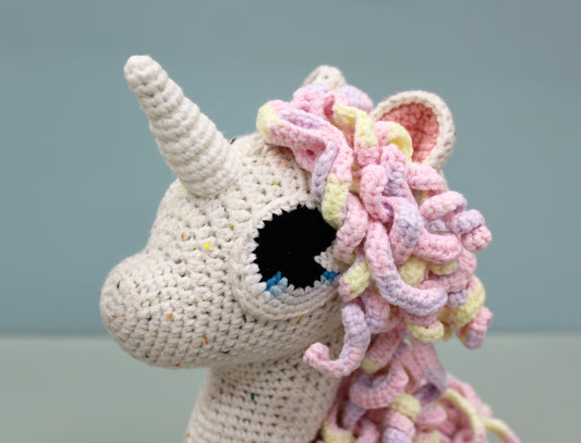Handmade crochet unicorn plush with multicolored mane and white horn, 13 inches.